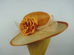 Upswept hat in sinamay and parisisal straw with silk flower and sinamay trim.