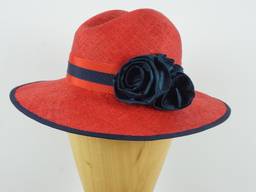Brilliant red parasisal straw with a flattering crown shape and navy silk rose detail.